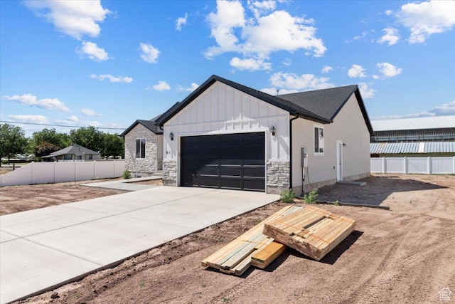 61 E 600 S, Nephi, UT 84648 - view of front of property with a garage, board and batten siding, driveway, and stone siding