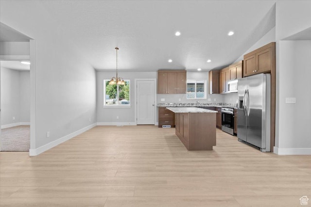 61 E 600 S, Nephi, UT 84648 - kitchen featuring appliances with stainless steel finishes, a center island, light wood-type flooring, light countertops, and plenty of natural light