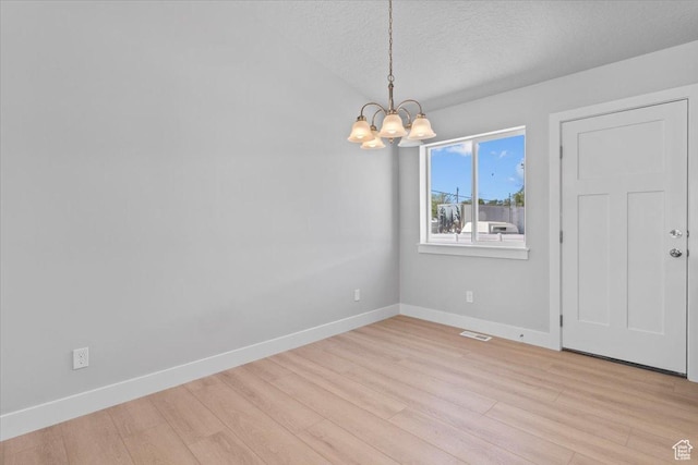 61 E 600 S, Nephi, UT 84648 - empty room with a chandelier, light wood-style floors, and a textured ceiling