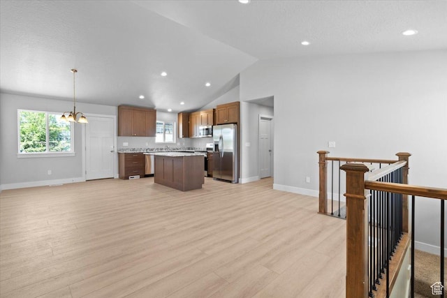 61 E 600 S, Nephi, UT 84648 - kitchen featuring appliances with stainless steel finishes, a center island, light countertops, a chandelier, and light wood-type flooring