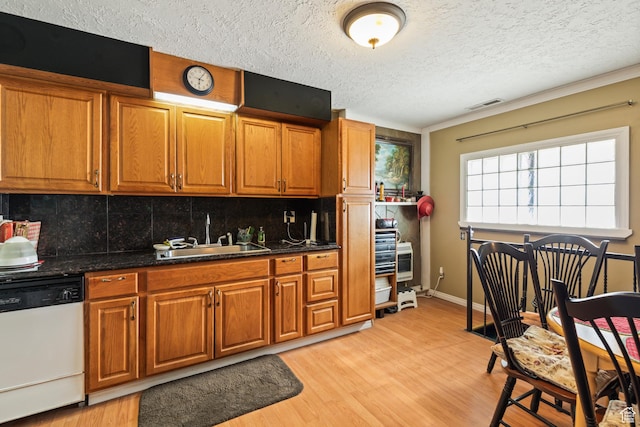 125 S Main St, Centerfield, UT 84622 - kitchen featuring dishwasher, decorative backsplash, brown cabinets, a textured ceiling, and light wood-style floors