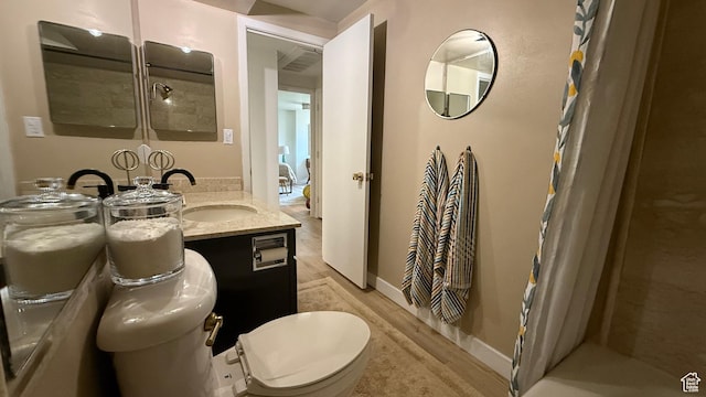 777 E S Temple N Unit 4B, Salt Lake City, UT 84102 - bathroom with wood finished floors, curtained shower, and vanity