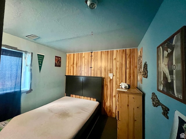675 W 2550 S, Price, UT 84501 - bedroom featuring wooden walls and a textured ceiling