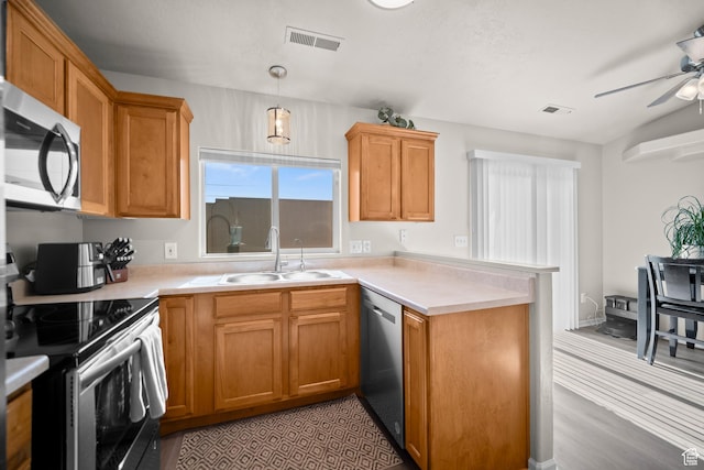 470 E 1100 S Unit 63, St George, UT 84790 - kitchen with appliances with stainless steel finishes, a peninsula, a ceiling fan, and light countertops