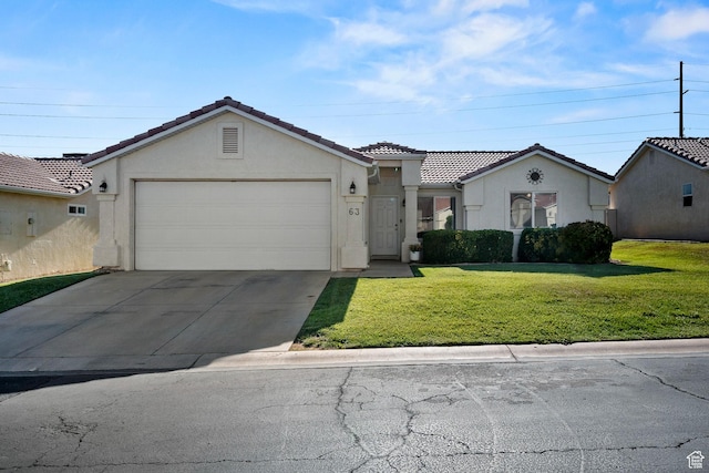 470 E 1100 S Unit 63, St George, UT 84790 - view of front of house with stucco siding, a garage, a tiled roof, a front lawn, and concrete driveway