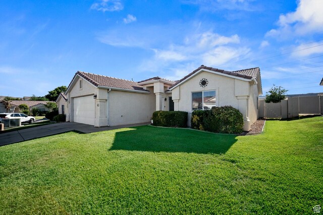 470 E 1100 S Unit 63, St George, UT 84790 - mediterranean / spanish-style house featuring stucco siding, an attached garage, a tiled roof, and driveway