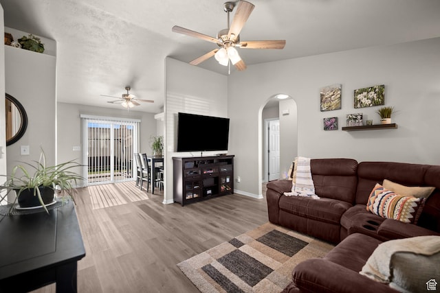 470 E 1100 S Unit 63, St George, UT 84790 - living room featuring a ceiling fan, arched walkways, lofted ceiling, and wood finished floors