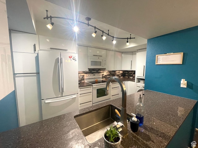 110 S 800 E Unit 300, Salt Lake City, UT 84102 - kitchen with white appliances, rail lighting, white cabinetry, decorative backsplash, and dark stone counters
