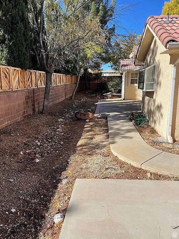 1118 E Chokeberry Dr, St George, UT 84790 - fenced backyard featuring a patio and cooling unit