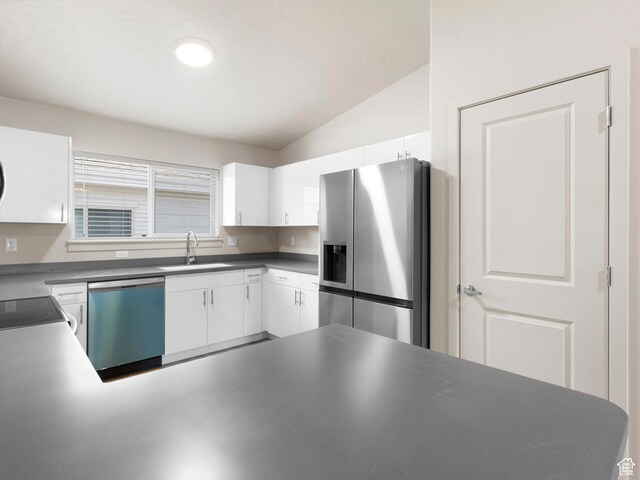 1140 W 950 N Unit C403, Orem, UT 84057 - kitchen featuring stainless steel appliances, lofted ceiling, white cabinets, dark countertops, and a peninsula