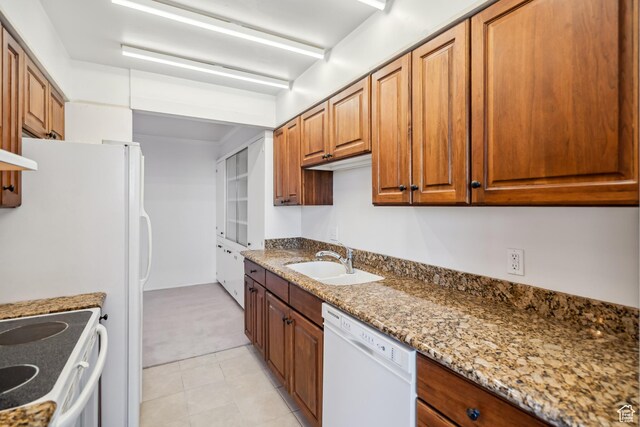 777 E S Temple N Unit 9J, Salt Lake City, UT 84102 - kitchen with white appliances, light carpet, brown cabinets, and light stone counters
