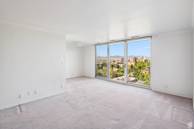 777 E S Temple N Unit 9J, Salt Lake City, UT 84102 - empty room with carpet floors, expansive windows, crown molding, and a ceiling fan