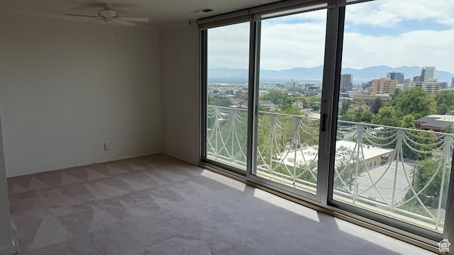 777 E S Temple N Unit 9J, Salt Lake City, UT 84102 - spare room with carpet, a ceiling fan, a mountain view, a view of city, and ornamental molding