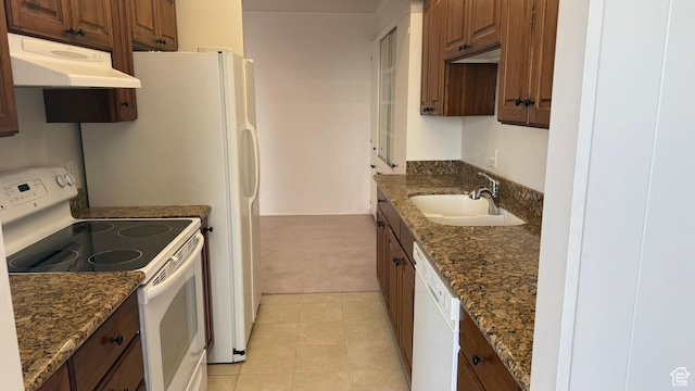 777 E S Temple N Unit 9J, Salt Lake City, UT 84102 - kitchen featuring white appliances, under cabinet range hood, light carpet, dark stone countertops, and crown molding