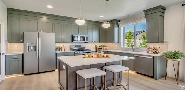 2158 W 2615 N Unit 137, Clinton, UT 84015 - kitchen with stainless steel appliances, light wood-style flooring, light countertops, tasteful backsplash, and recessed lighting