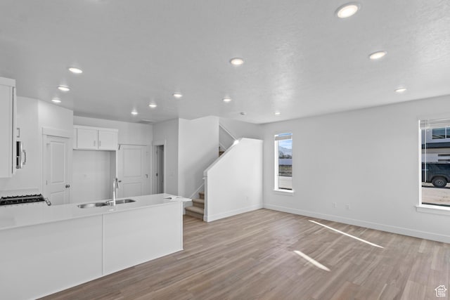 511 S 1225 W Unit 102, Logan, UT 84321 - unfurnished living room featuring recessed lighting, light wood-type flooring, and stairway