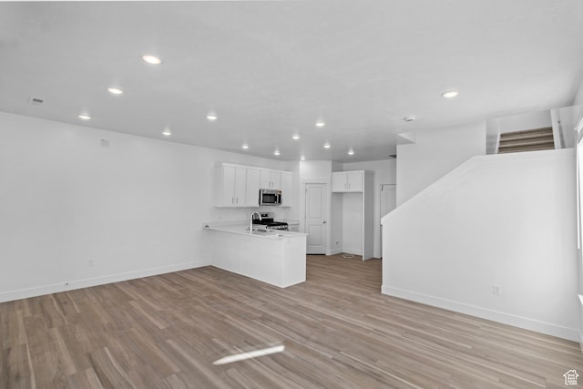 511 S 1225 W Unit 102, Logan, UT 84321 - unfurnished living room featuring recessed lighting, stairs, and light wood-style flooring