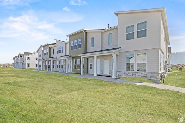 511 S 1225 W Unit 102, Logan, UT 84321 - view of front of home with a residential view, a front yard, and stone siding