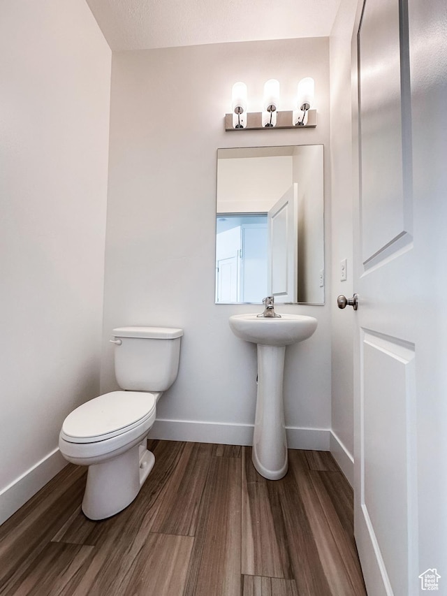 511 S 1225 W Unit 102, Logan, UT 84321 - half bathroom with toilet and wood finished floors