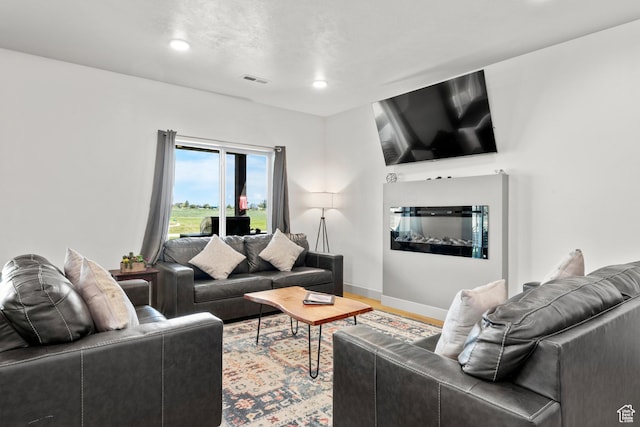 140 W 150 S Unit I34, Garden City, UT 84028 - living area with recessed lighting, wood finished floors, and a glass covered fireplace