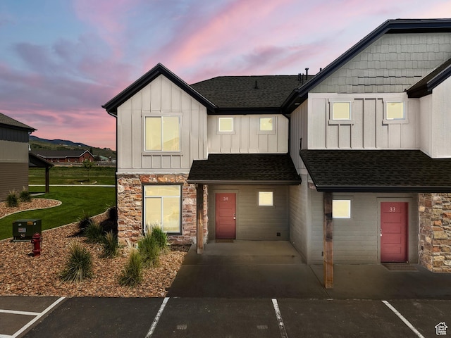 140 W 150 S Unit I34, Garden City, UT 84028 - townhome / multi-family property featuring stone siding, board and batten siding, roof with shingles, and uncovered parking