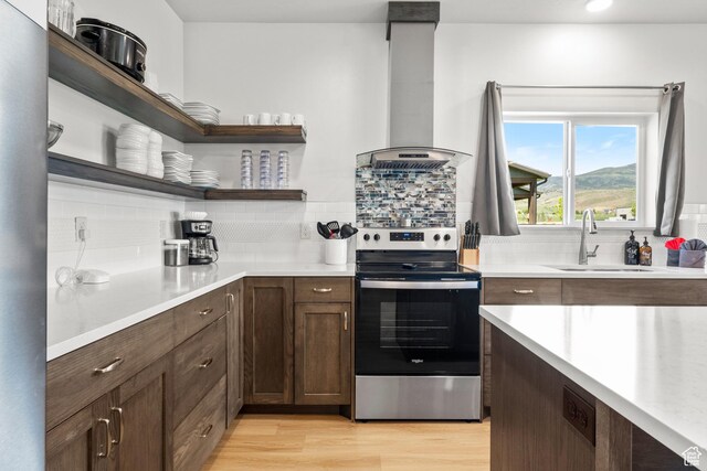 140 W 150 S Unit I34, Garden City, UT 84028 - kitchen with stainless steel electric stove, ventilation hood, open shelves, light countertops, and tasteful backsplash