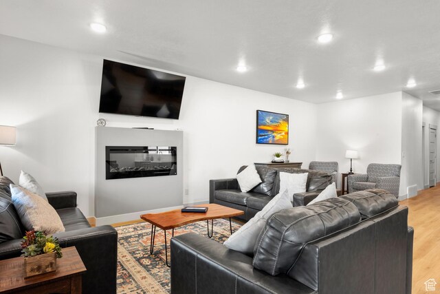 140 W 150 S Unit I34, Garden City, UT 84028 - living room featuring light wood finished floors, recessed lighting, and a glass covered fireplace