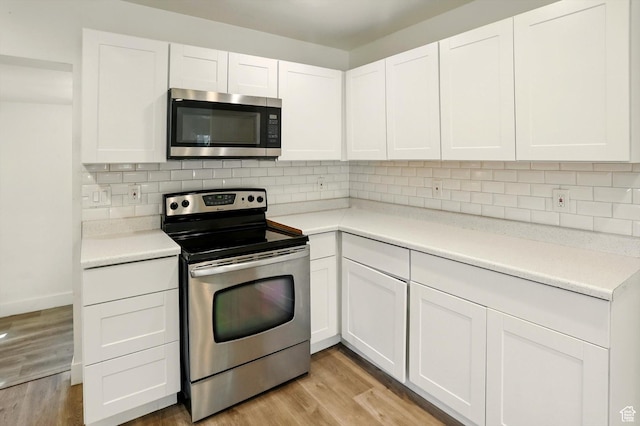 840 E 22nd St S, Ogden, UT 84401 - kitchen with appliances with stainless steel finishes, white cabinets, and light wood-type flooring