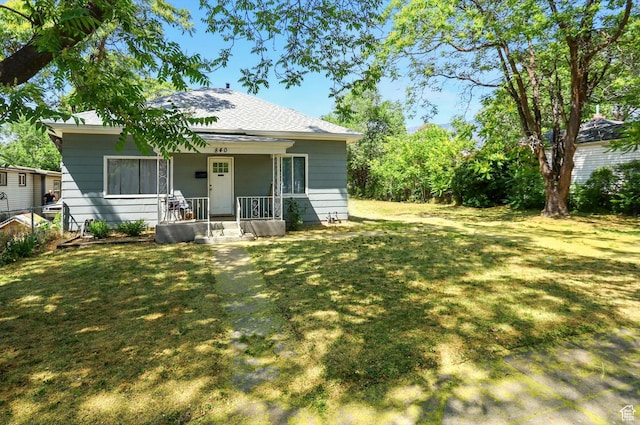 840 E 22nd St S, Ogden, UT 84401 - back of house featuring covered porch, a lawn, and roof with shingles