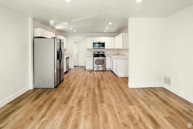 840 E 22nd St S, Ogden, UT 84401 - kitchen featuring appliances with stainless steel finishes, light countertops, white cabinetry, decorative backsplash, and recessed lighting