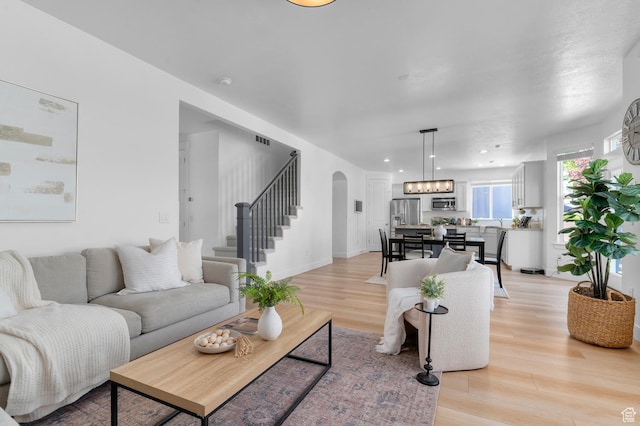 68 N Eden Way, Vineyard, UT 84059 - living area with arched walkways, light wood-style floors, stairs, and recessed lighting