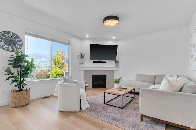 68 N Eden Way, Vineyard, UT 84059 - living area featuring wood finished floors, a tiled fireplace, and recessed lighting