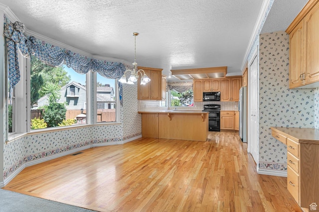 4630 S Stockbridge Ln, Millcreek, UT 84117 - kitchen with black microwave, wallpapered walls, range, freestanding refrigerator, and light wood-style floors
