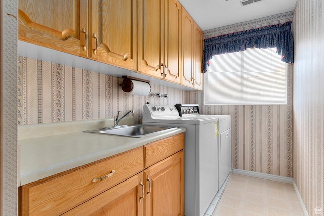 4630 S Stockbridge Ln, Millcreek, UT 84117 - washroom featuring wallpapered walls, cabinet space, washing machine and clothes dryer, and light flooring