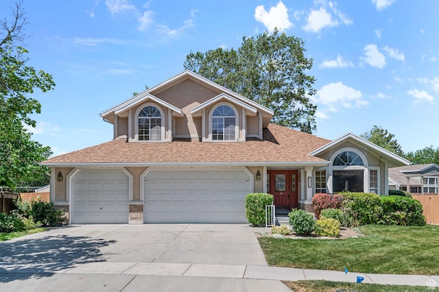4630 S Stockbridge Ln, Millcreek, UT 84117 - view of front of house featuring driveway, roof with shingles, stucco siding, brick siding, and a garage