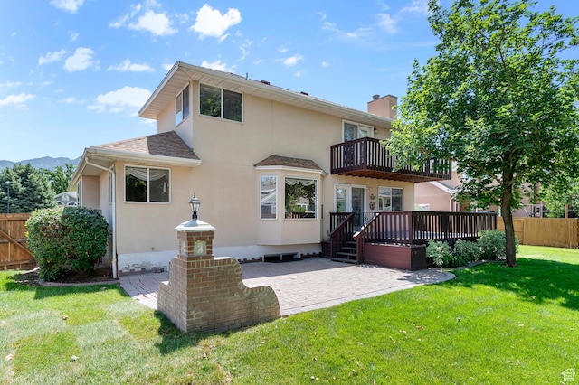 4630 S Stockbridge Ln, Millcreek, UT 84117 - rear view of property featuring a balcony, stucco siding, a patio area, and a deck