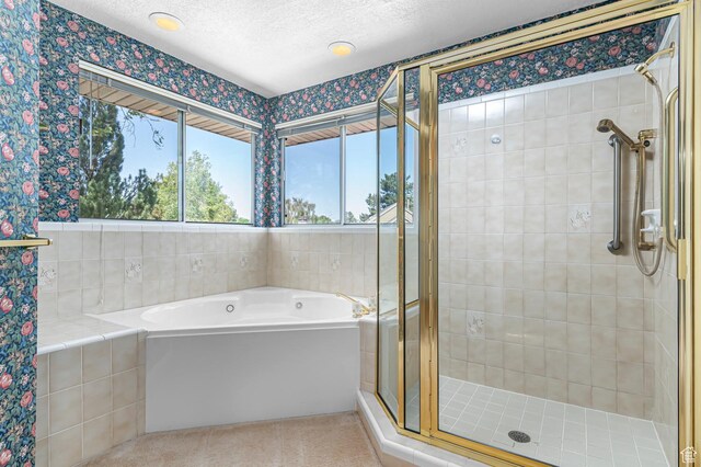 4630 S Stockbridge Ln, Millcreek, UT 84117 - full bathroom with plenty of natural light, a stall shower, a garden tub, wallpapered walls, and a textured ceiling