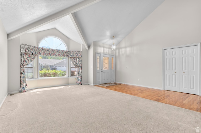 4630 S Stockbridge Ln, Millcreek, UT 84117 - unfurnished living room featuring carpet, high vaulted ceiling, and beamed ceiling