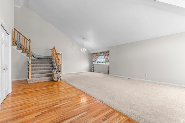 4630 S Stockbridge Ln, Millcreek, UT 84117 - unfurnished living room featuring stairway, a chandelier, wood finished floors, carpet flooring, and high vaulted ceiling