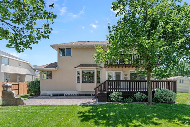 4630 S Stockbridge Ln, Millcreek, UT 84117 - rear view of house with stucco siding, a wooden deck, a patio area, and roof with shingles