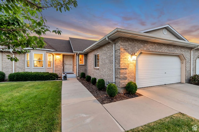 145 N 240 E, Orem, UT 84057 - ranch-style home with a front yard, a garage, brick siding, and driveway