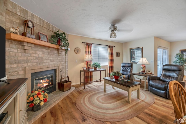 145 N 240 E, Orem, UT 84057 - living room featuring a brick fireplace, ceiling fan, light wood-type flooring, and a textured ceiling