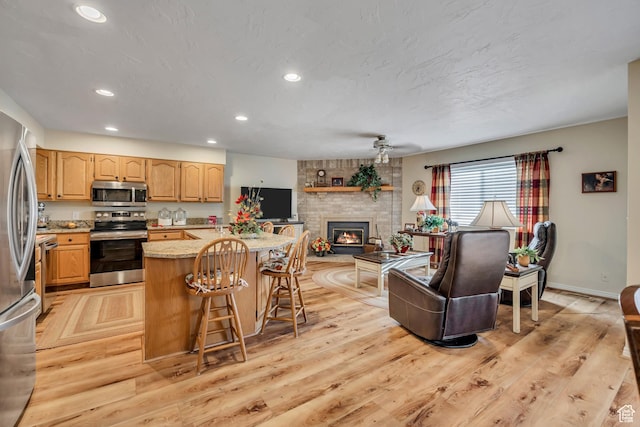 145 N 240 E, Orem, UT 84057 - kitchen featuring stainless steel appliances, light wood-style flooring, recessed lighting, and a kitchen breakfast bar