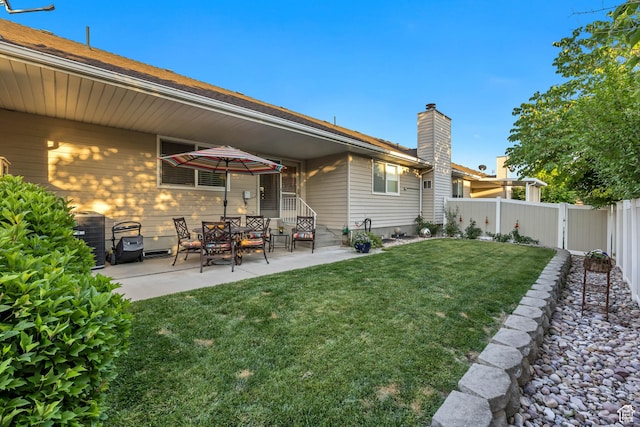 145 N 240 E, Orem, UT 84057 - rear view of house featuring a fenced backyard, a patio area, and a chimney