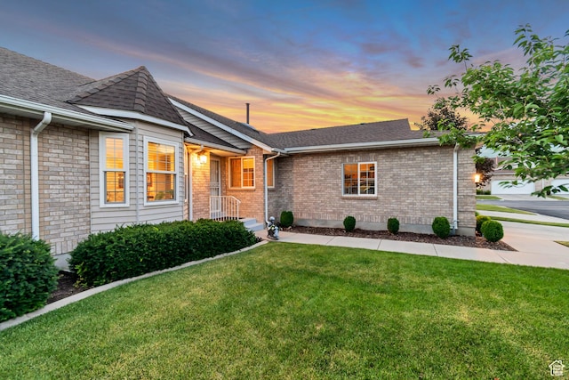 145 N 240 E, Orem, UT 84057 - ranch-style house with a front yard, roof with shingles, and brick siding