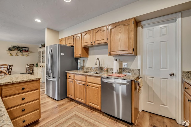 145 N 240 E, Orem, UT 84057 - kitchen featuring appliances with stainless steel finishes, light wood-style flooring, light stone counters, and recessed lighting