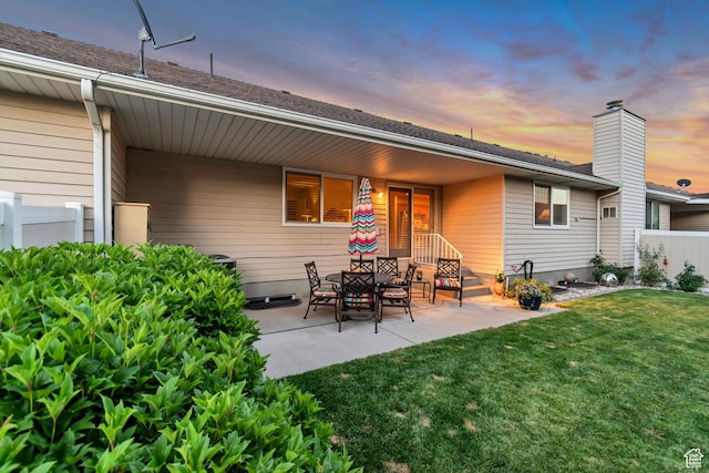 145 N 240 E, Orem, UT 84057 - back of property at dusk featuring a patio and a chimney