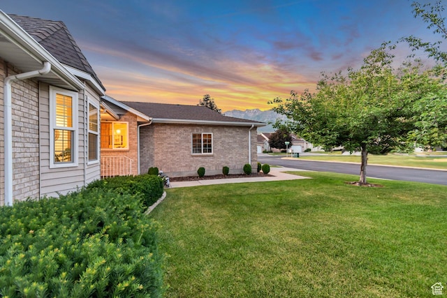 145 N 240 E, Orem, UT 84057 - view of property exterior with brick siding, a lawn, and roof with shingles