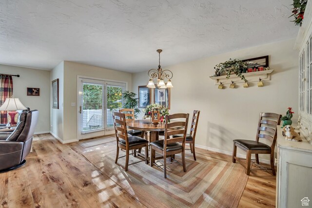 145 N 240 E, Orem, UT 84057 - dining area featuring a chandelier, light wood-style floors, and a textured ceiling