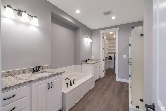 1766 S 1850 W Unit 08, Mapleton, UT 84664 - full bath with washer / dryer, a spacious closet, vanity, a garden tub, and wood finished floors
